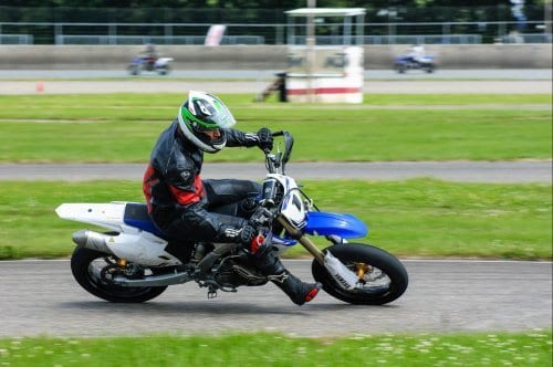 motorcrosser rijd een bocht op motorcircuit Motorcrosser rijd een bocht op motorcircuit
